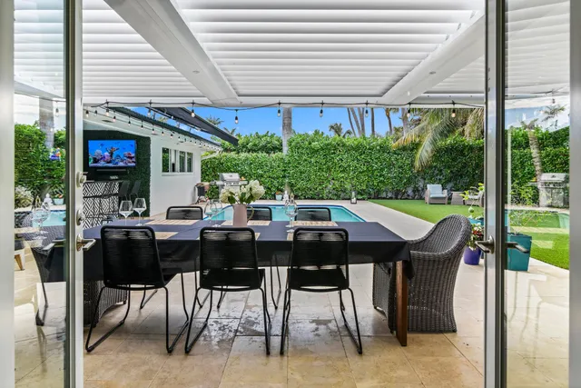 a view of an outside dining space with furniture