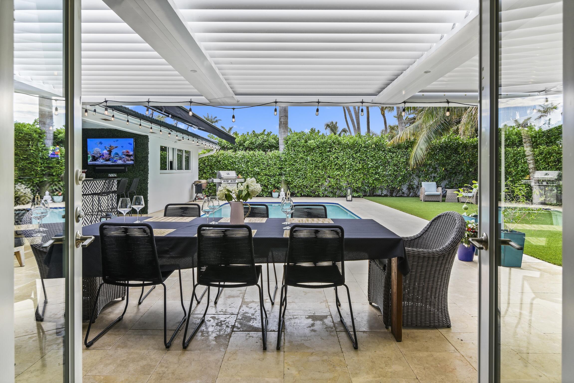 3481 Northeast 31st Avenue Lighthouse Point, FL 33064 - Photo 15 of 33 a view of an outside dining space with furniture
