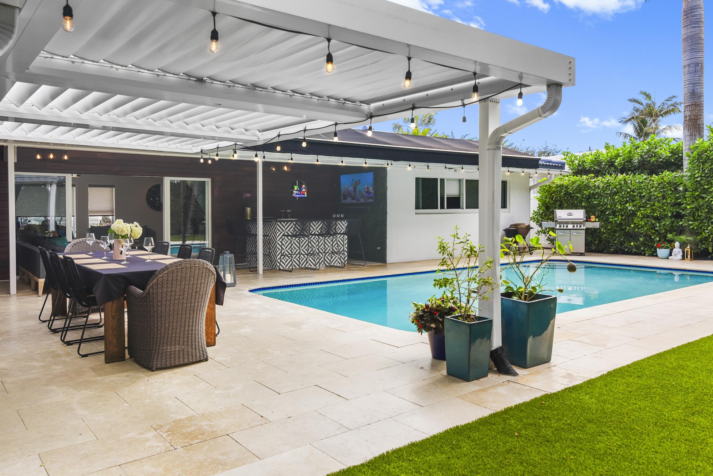 3481 Northeast 31st Avenue Lighthouse Point, FL 33064 - Photo 16 of 33 a view of a patio with a table and chairs
