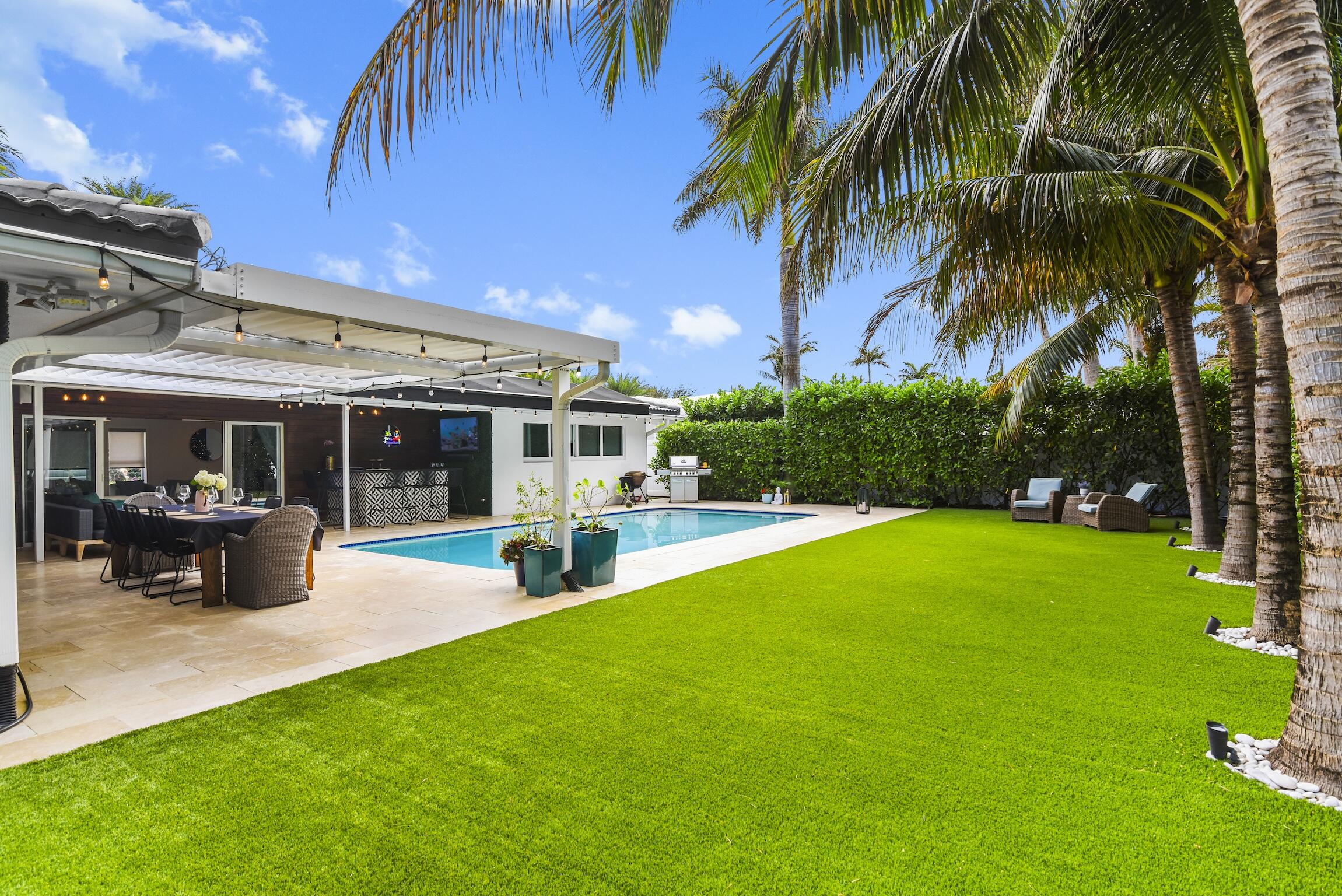 3481 Northeast 31st Avenue Lighthouse Point, FL 33064 - Photo 18 of 33 a view of a house with a swimming pool and sitting area