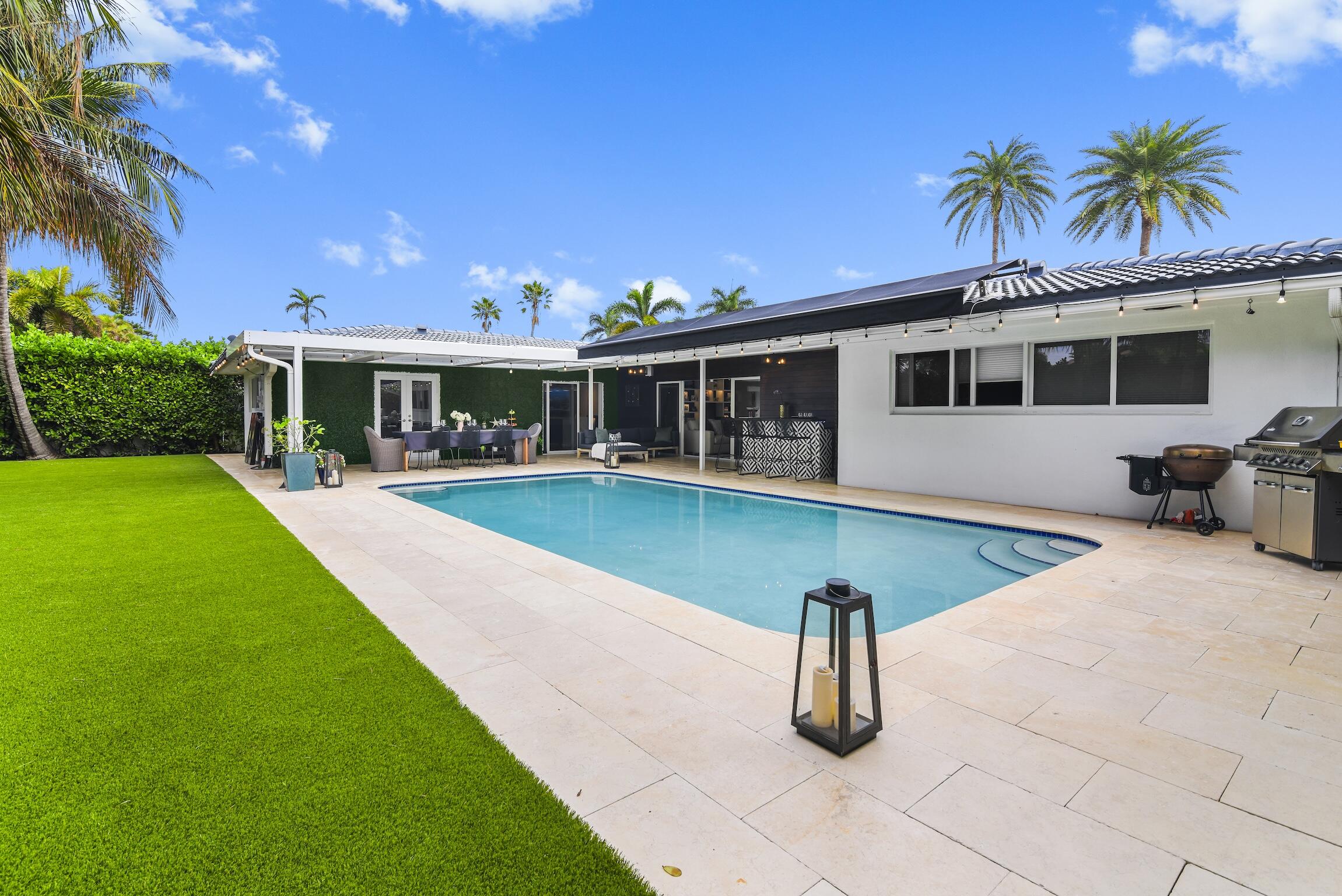 3481 Northeast 31st Avenue Lighthouse Point, FL 33064 - Photo 20 of 33 a front view of a house with garden
