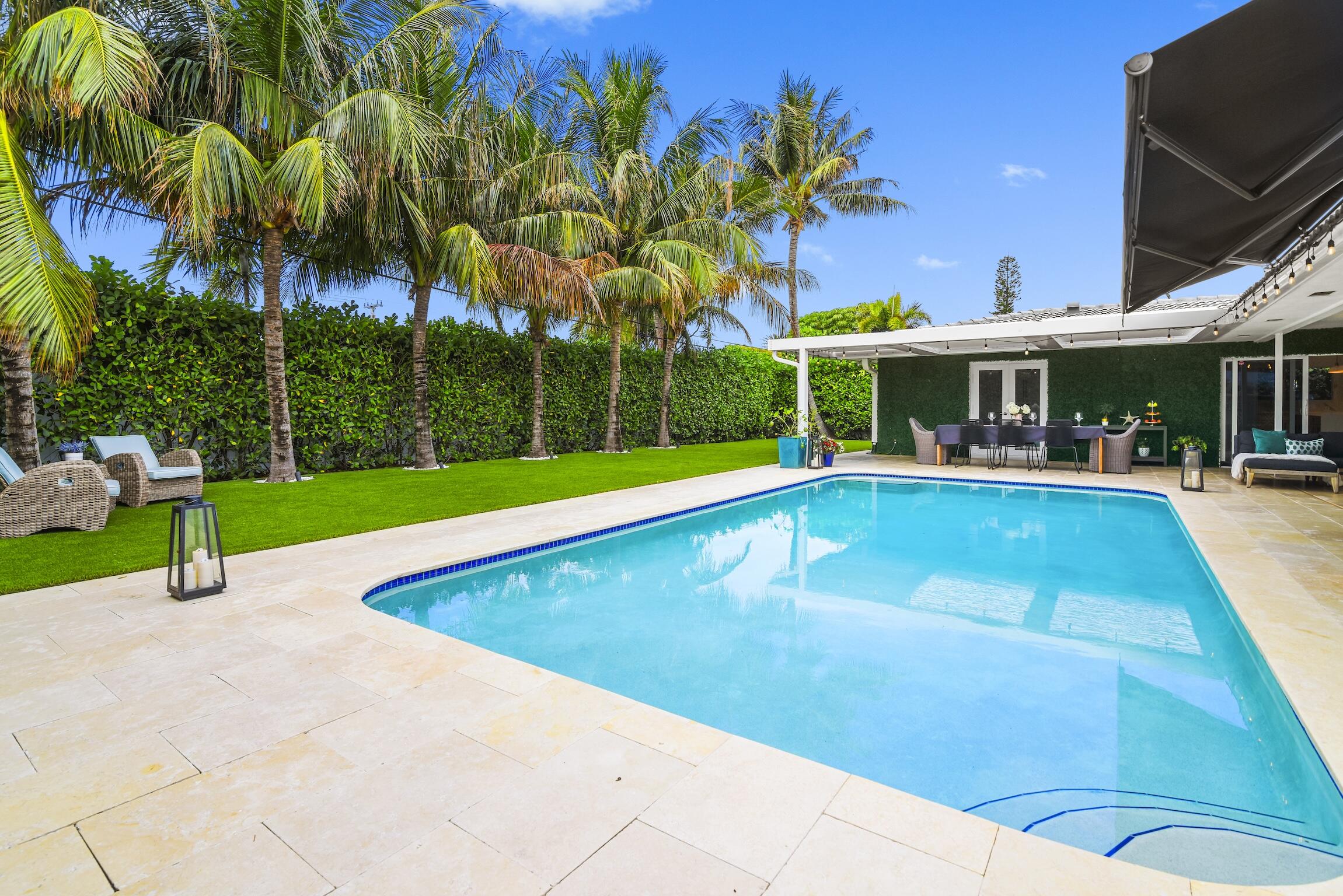 3481 Northeast 31st Avenue Lighthouse Point, FL 33064 - Photo 22 of 33 a swimming pool with outdoor seating and yard