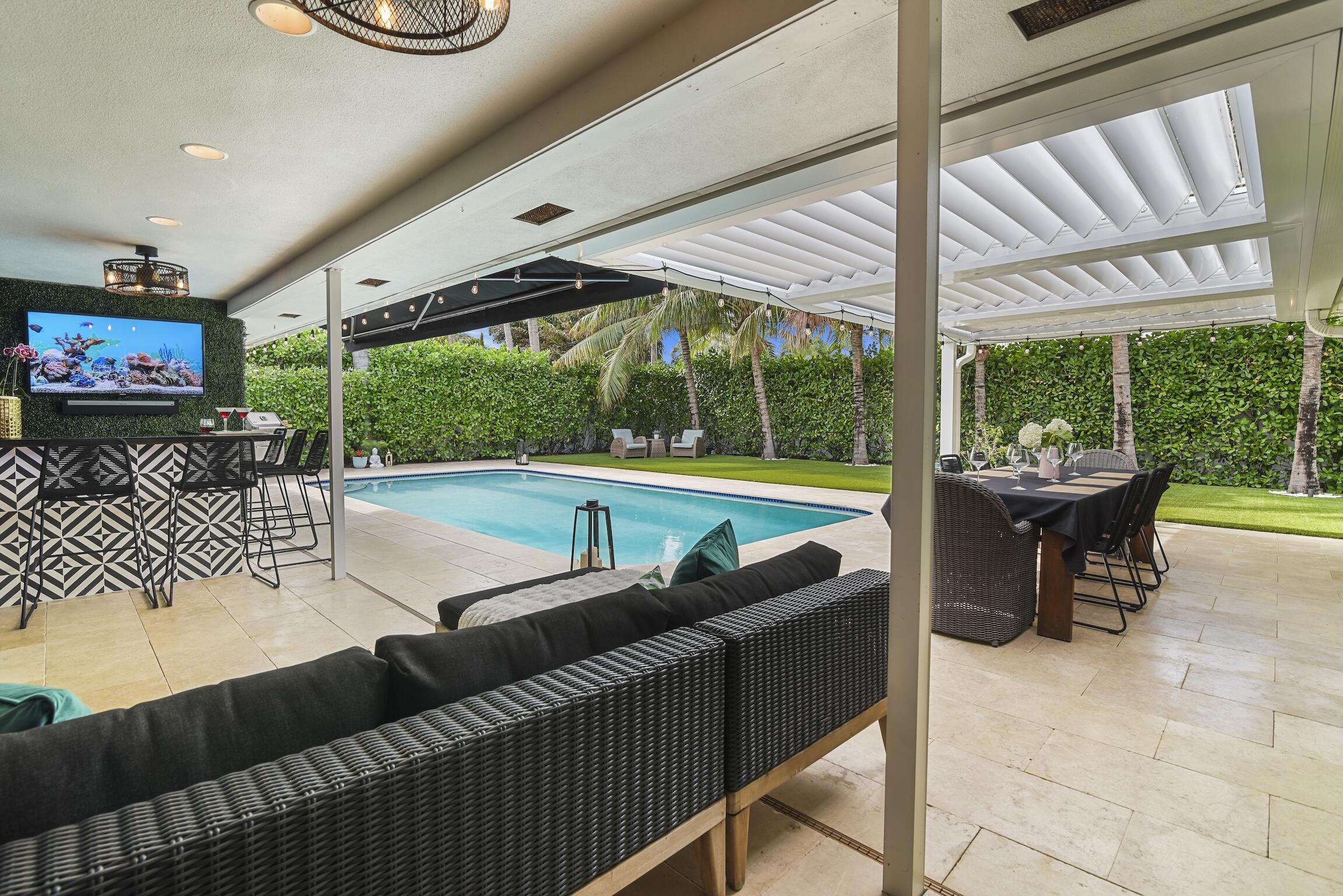 3481 Northeast 31st Avenue Lighthouse Point, FL 33064 - Photo 26 of 33 a view of a patio with a table and chairs