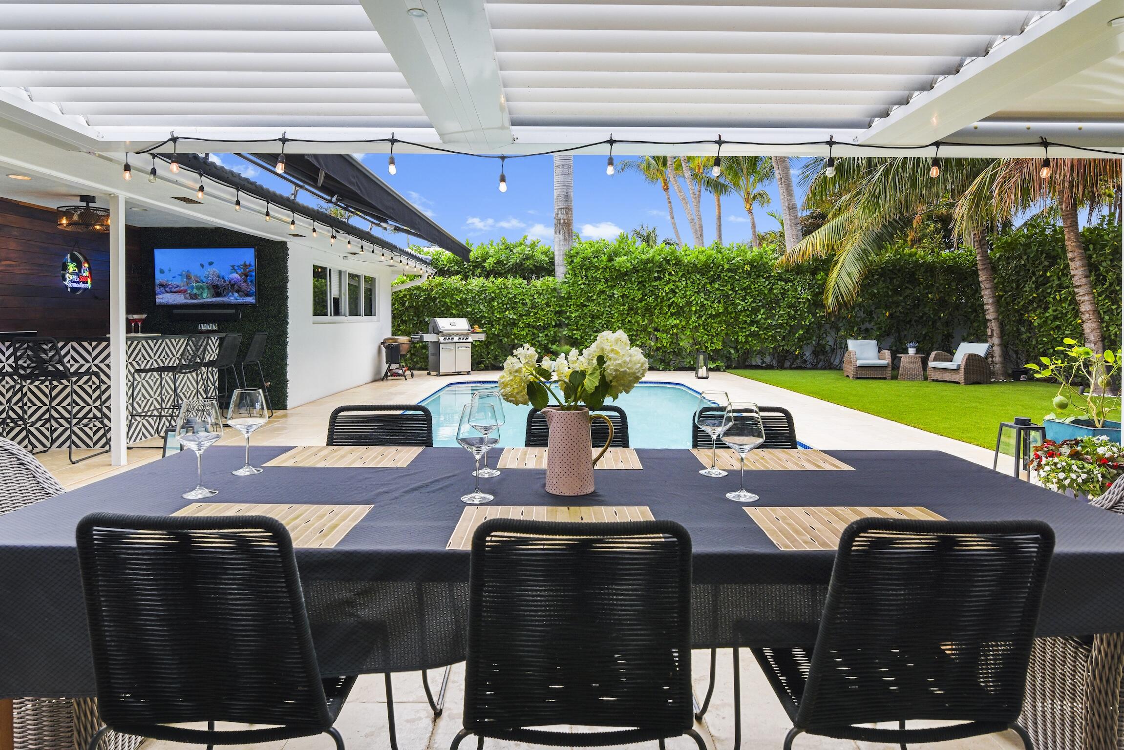 3481 Northeast 31st Avenue Lighthouse Point, FL 33064 - Photo 30 of 33 a view of an outside dining space with furniture