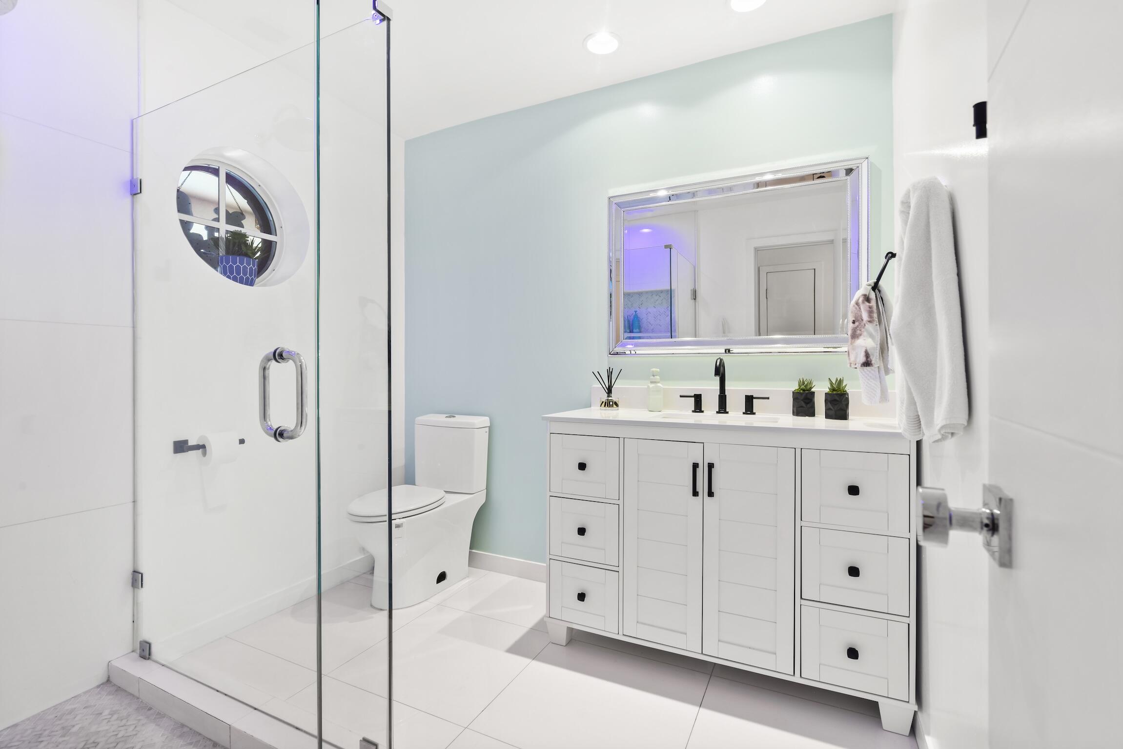 3481 Northeast 31st Avenue Lighthouse Point, FL 33064 - Photo 31 of 33 a bathroom with a double vanity sink mirror and toilet