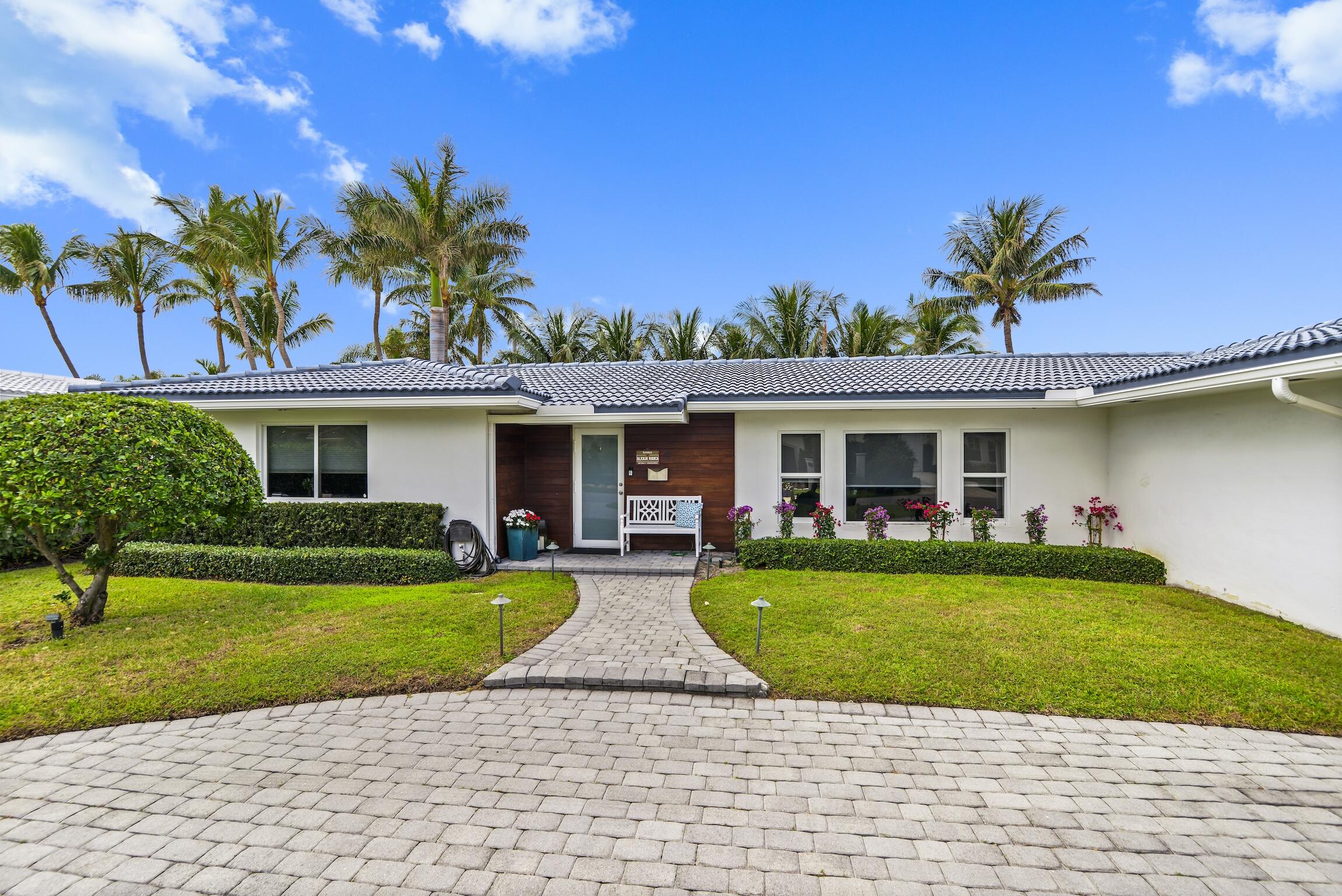 3481 Northeast 31st Avenue Lighthouse Point, FL 33064 - Photo 32 of 33 a front view of a house with garden