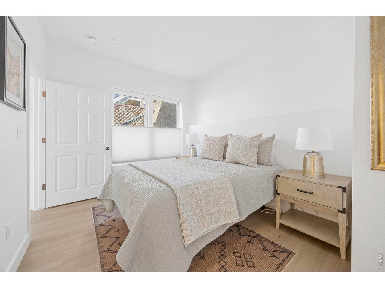 4655 13th Street Boulder, CO 80304 - Photo 14 of 23 a bedroom with a bed and a painting on the wall