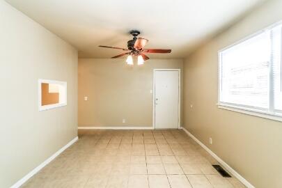 5408 31st Street Lubbock, TX 79407 - Photo 9 of 33 a view of a room with a window and a fan