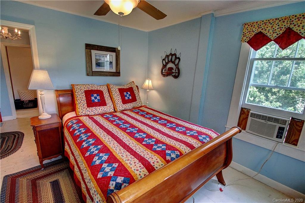 24 Belmont Church Road Clyde, NC 28721 - Photo 22 of 44 a bed room with a bed and a lamp