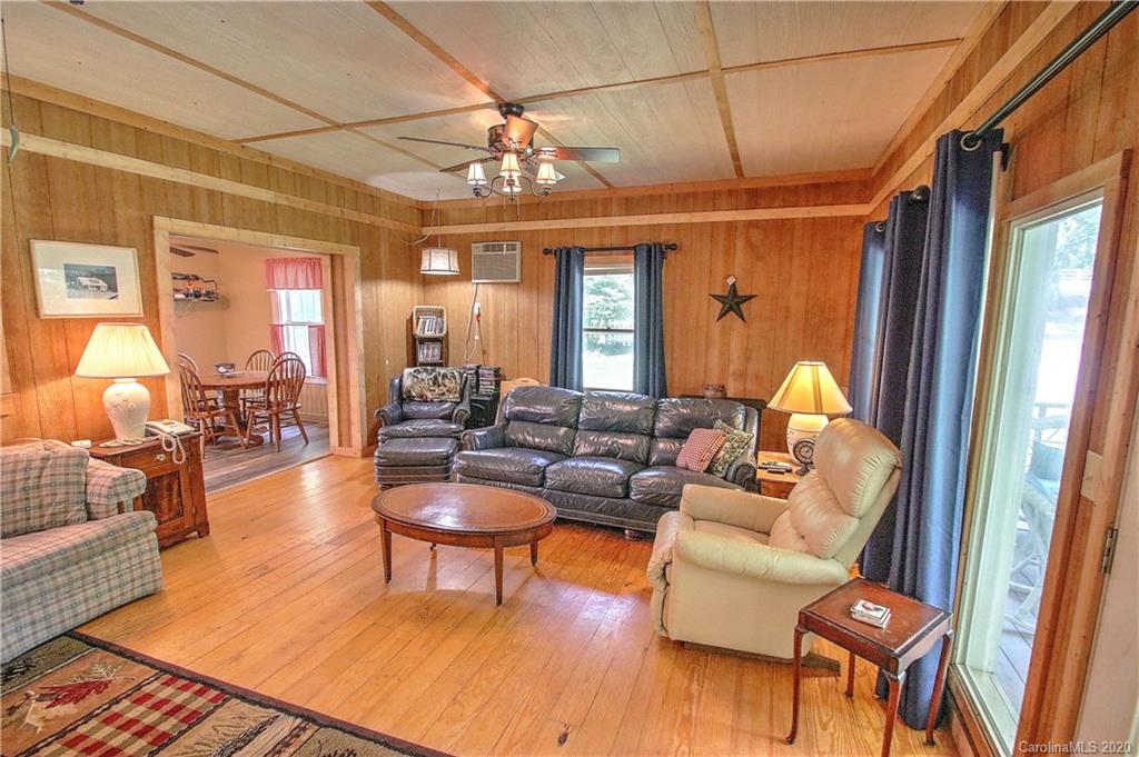 24 Belmont Church Road Clyde, NC 28721 - Photo 8 of 44 a living room with furniture a chandelier and wooden floor