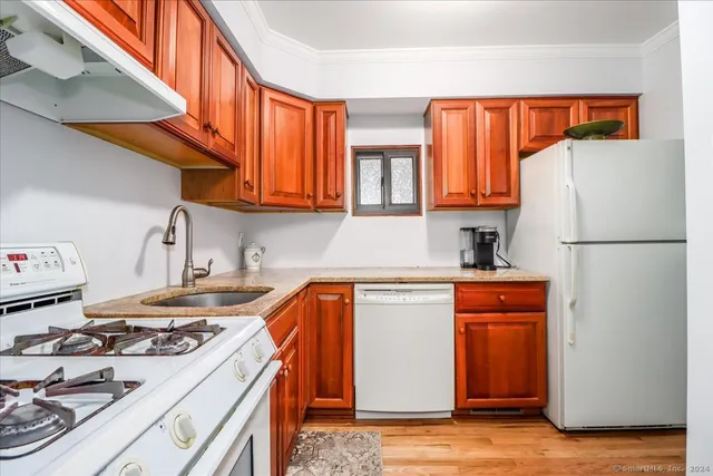 a kitchen with stainless steel appliances granite countertop a refrigerator and a stove