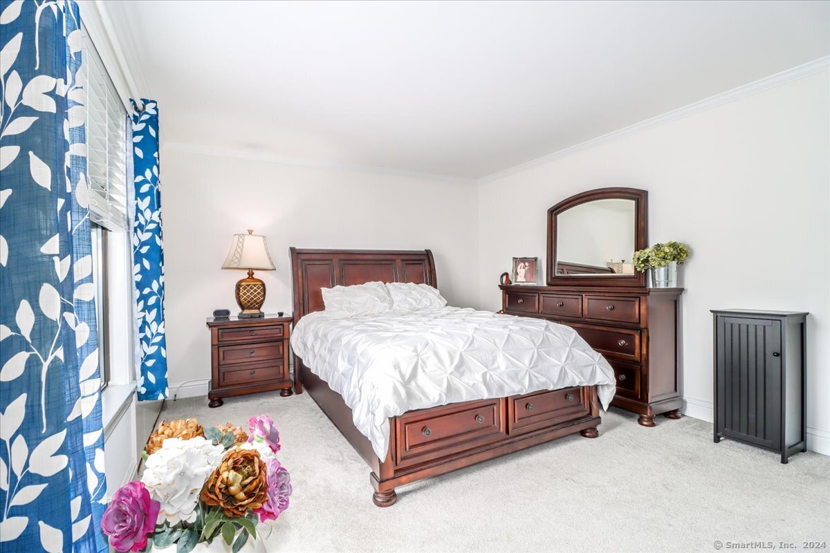 22 Olcott Way, Unit 22 Ridgefield, CT 06877 - Photo 14 of 20 a bed room with a bed and a couch