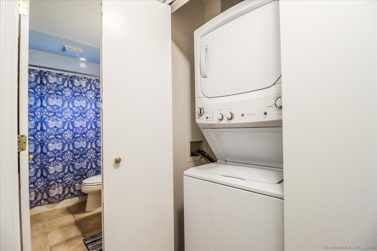 22 Olcott Way, Unit 22 Ridgefield, CT 06877 - Photo 16 of 20 a utility room with dryer and washer