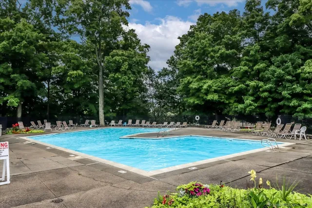 a view of a swimming pool with an outdoor space and seating area