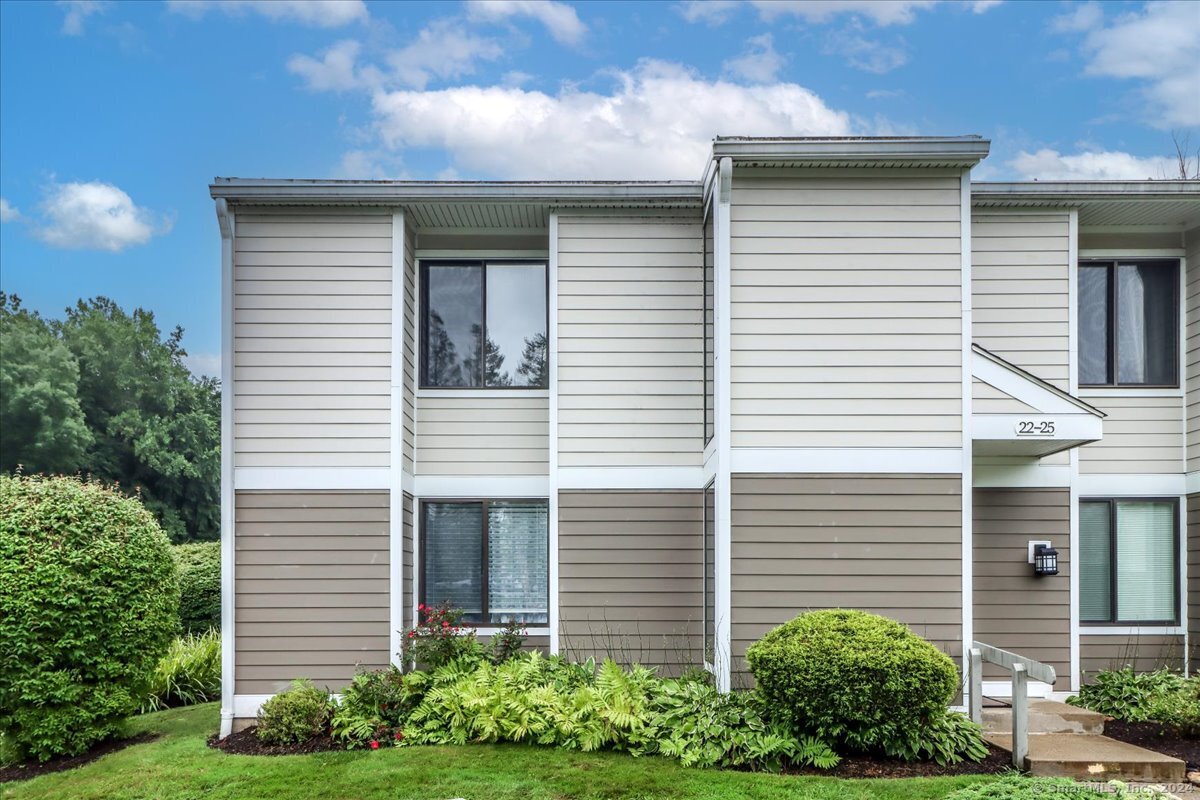 22 Olcott Way, Unit 22 Ridgefield, CT 06877 - Photo 2 of 20 a view of a house with a yard and plants