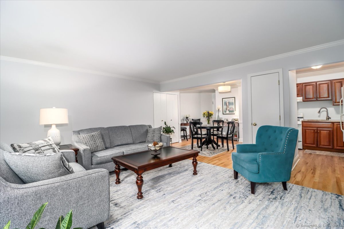 22 Olcott Way, Unit 22 Ridgefield, CT 06877 - Photo 6 of 20 a living room with furniture and a wooden floor