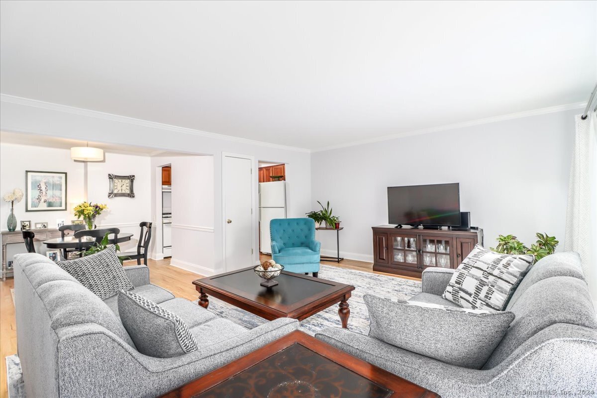 22 Olcott Way, Unit 22 Ridgefield, CT 06877 - Photo 7 of 20 a living room with furniture and a flat screen tv
