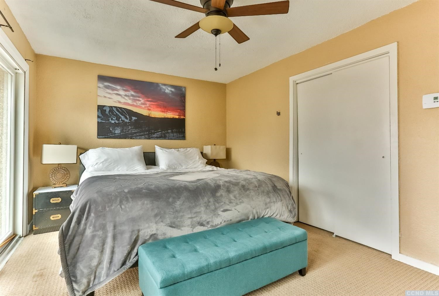 13 Scribner Hollow Road, Unit B1 Hunter, NY 12442 - Photo 16 of 37 a bed sitting in a bedroom next to a bathroom