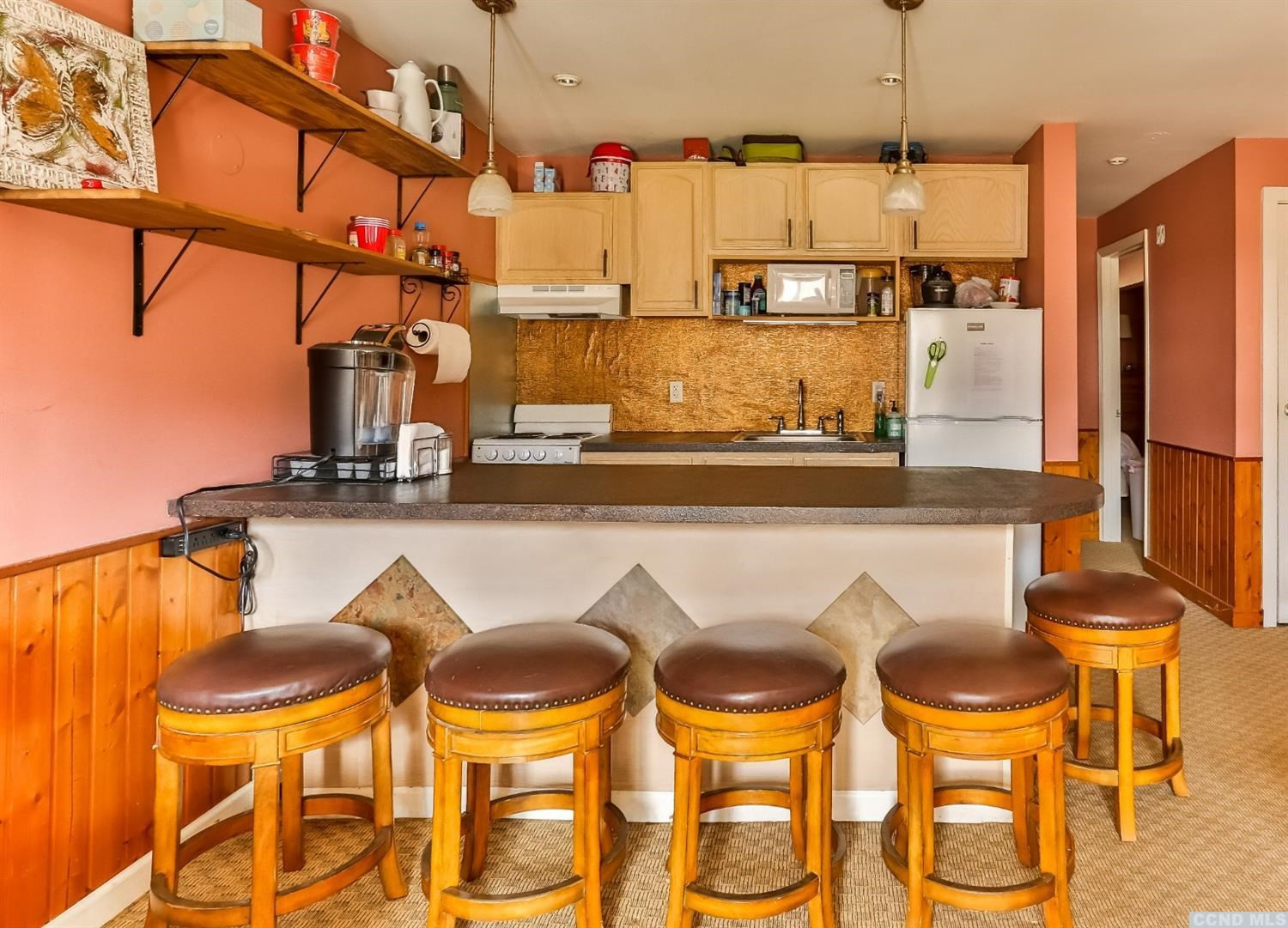 13 Scribner Hollow Road, Unit B1 Hunter, NY 12442 - Photo 26 of 37 a kitchen with a dining table and chairs