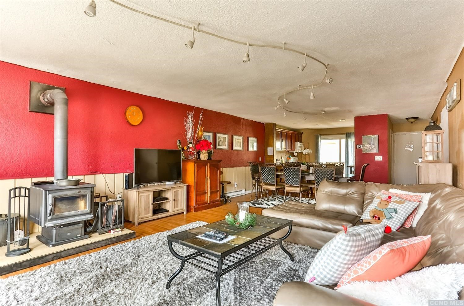 13 Scribner Hollow Road, Unit B1 Hunter, NY 12442 - Photo 8 of 37 a living room with furniture a flat screen tv and a fireplace