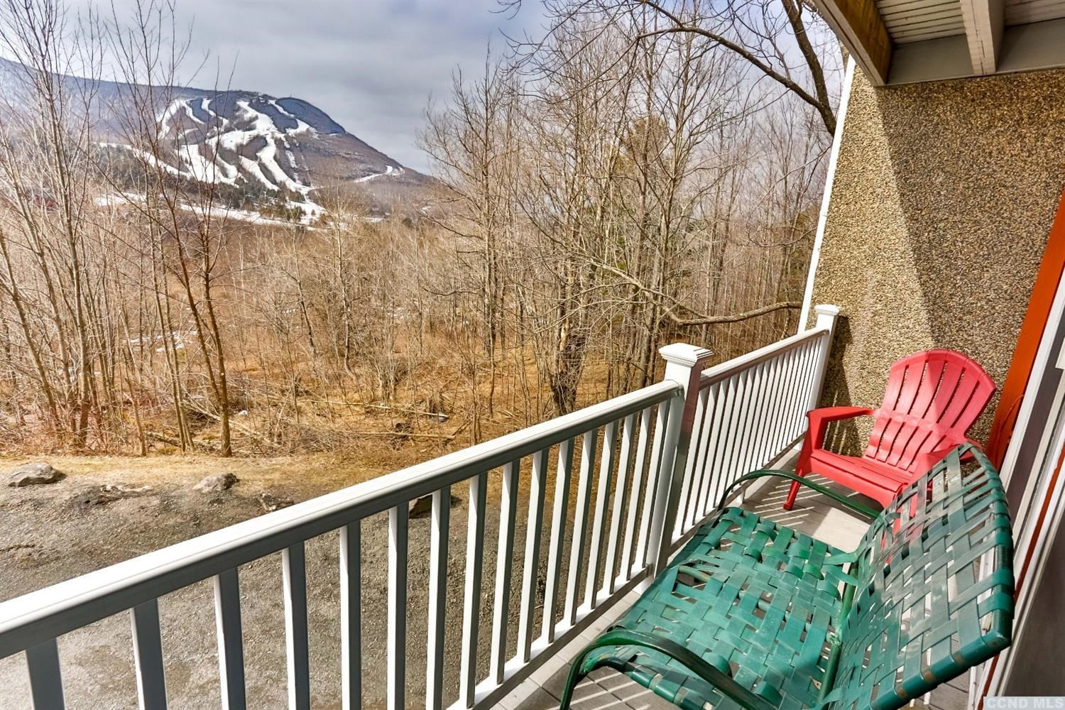 13 Scribner Hollow Road, Unit B1 Hunter, NY 12442 - Photo 9 of 37 a balcony with wooden floor and fence