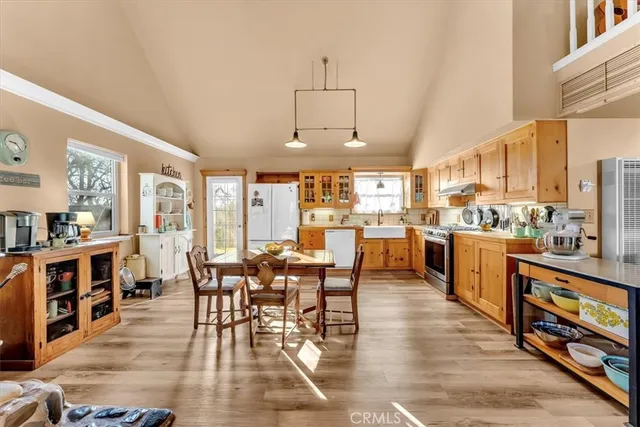 a kitchen with refrigerator cabinets and wooden floor