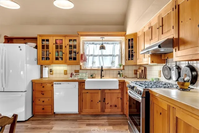 a spacious bedroom with a bed a window and dresser