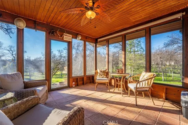 a living room with furniture and a floor to ceiling window