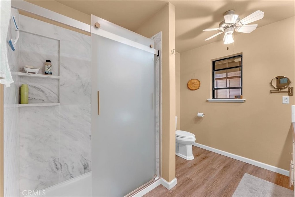 18810 Phyllis Road Cottonwood, CA 96022 - Photo 23 of 71 a bathroom with a granite countertop shower a toilet and a sink