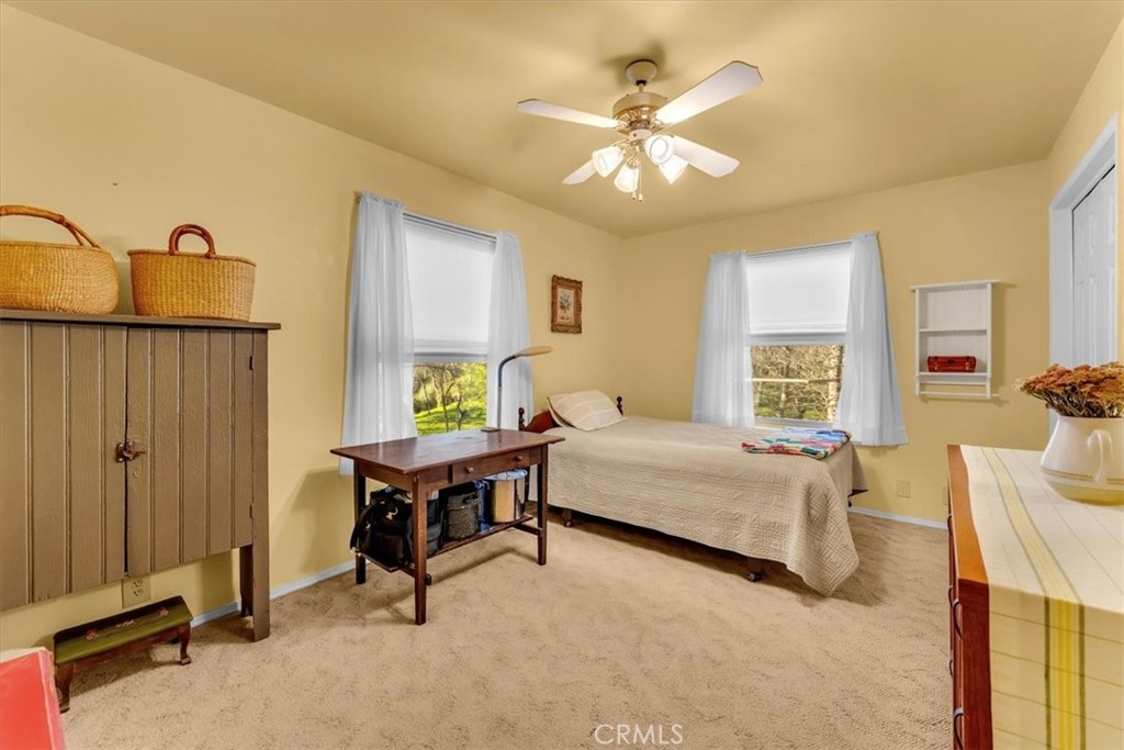 18810 Phyllis Road Cottonwood, CA 96022 - Photo 27 of 71 a bedroom with a bed and a chandelier