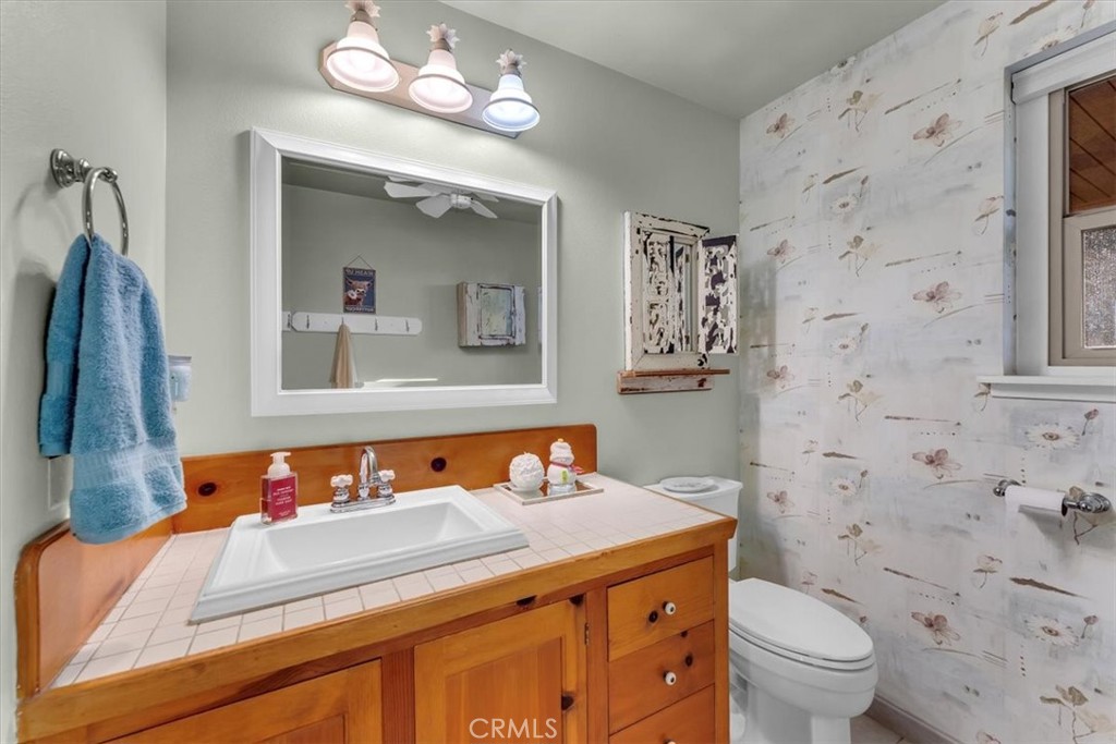 18810 Phyllis Road Cottonwood, CA 96022 - Photo 34 of 71 a bathroom with a sink a toilet and a mirror