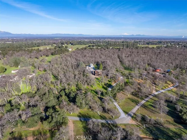 a backyard of a house with a yard and outdoor seating