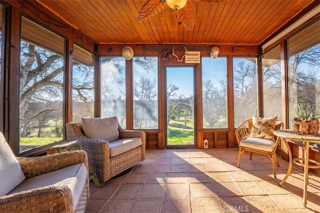 18810 Phyllis Road Cottonwood, CA 96022 - Photo 62 of 71 a living room with furniture and a floor to ceiling window