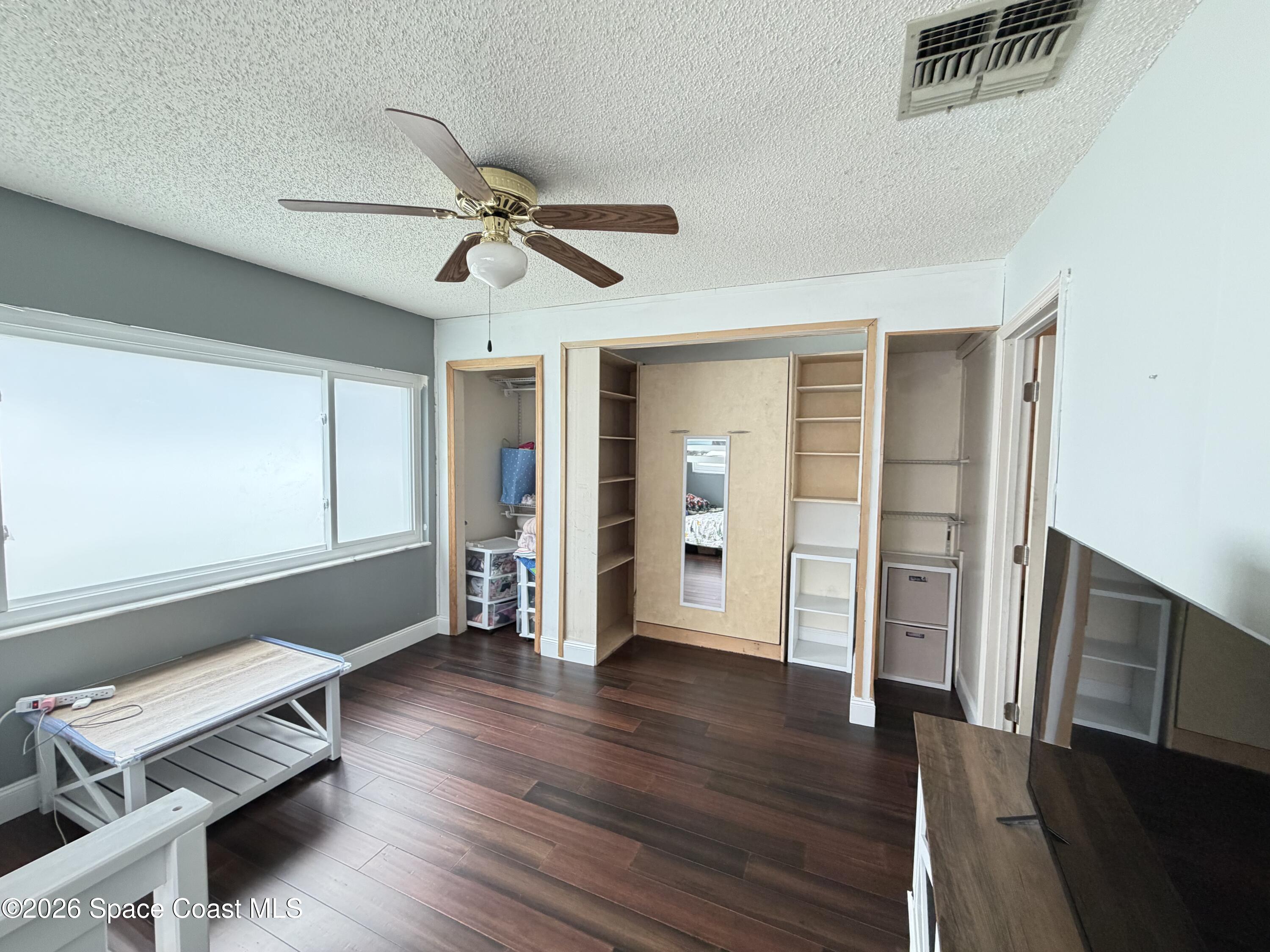 1578 West Powder Horn Road Titusville, FL 32796 - Photo 4 of 22 a living room with wooden floor and furniture