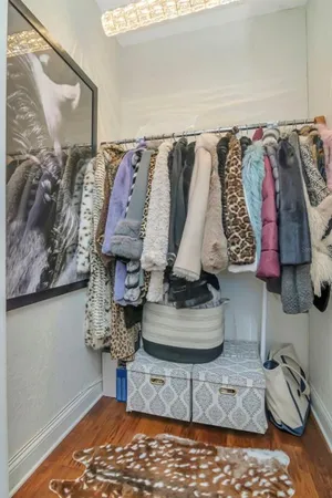 a living room with furniture a flat screen tv and kitchen view