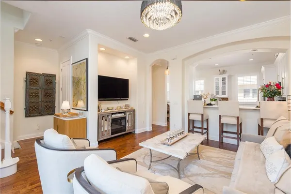 a vase of flowers sitting on a table with wooden floor
