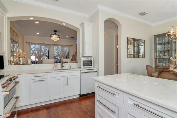 a front view of multi story residential apartment building with yard and sign board