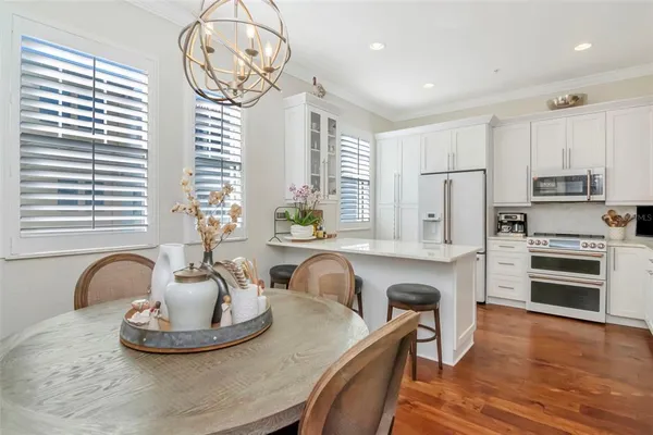 a front view of a house with a yard and potted plants