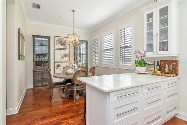 a view of a house with a yard and potted plants