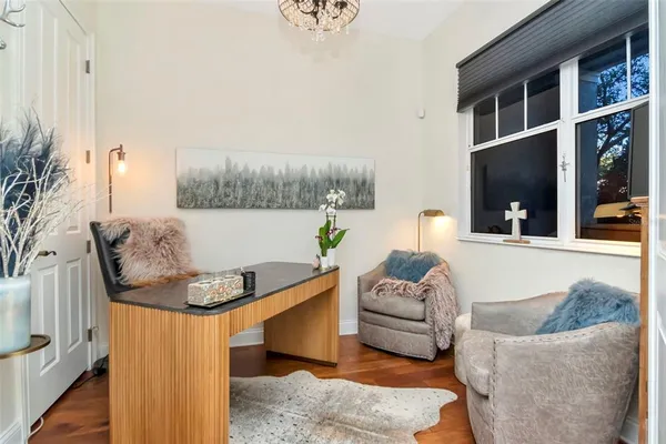 a bedroom with a bed and a potted plant