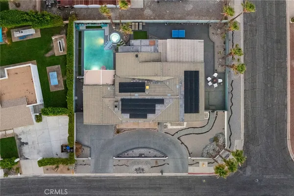a aerial view of a house with swimming pool having outdoor seating