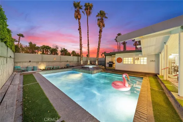 a front view of a house with swimming pool and porch