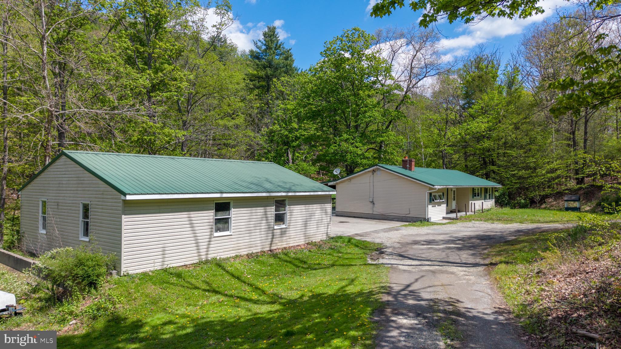 243 Lucas Road Bellefonte, PA 16823 - Photo 1 of 32 a aerial view of a house with a yard and large trees