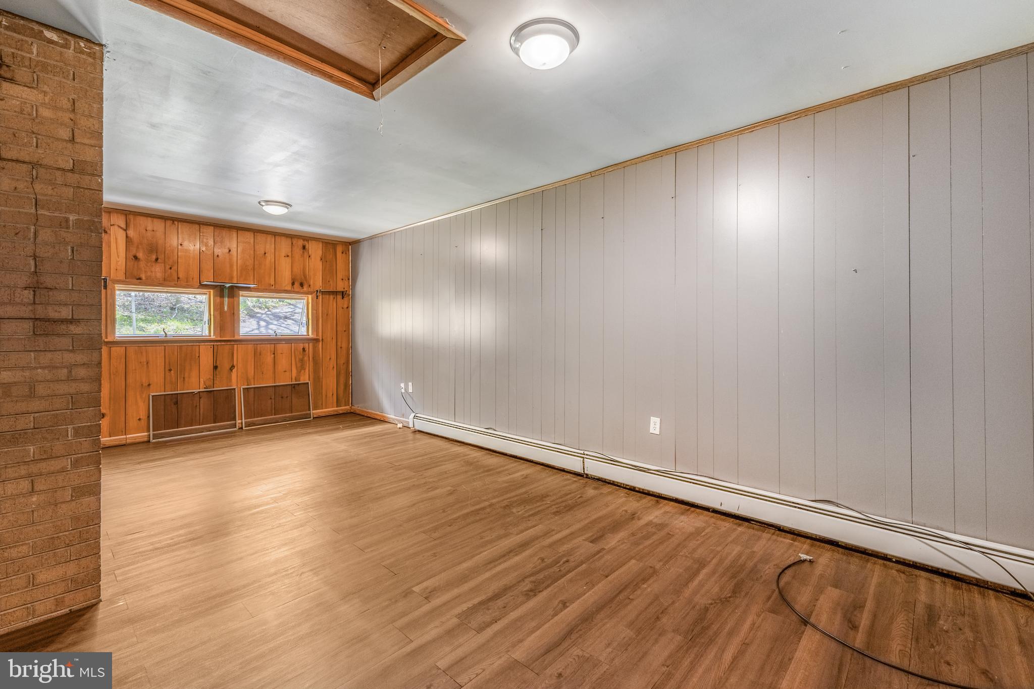 243 Lucas Road Bellefonte, PA 16823 - Photo 11 of 32 an empty room with wooden floor and windows