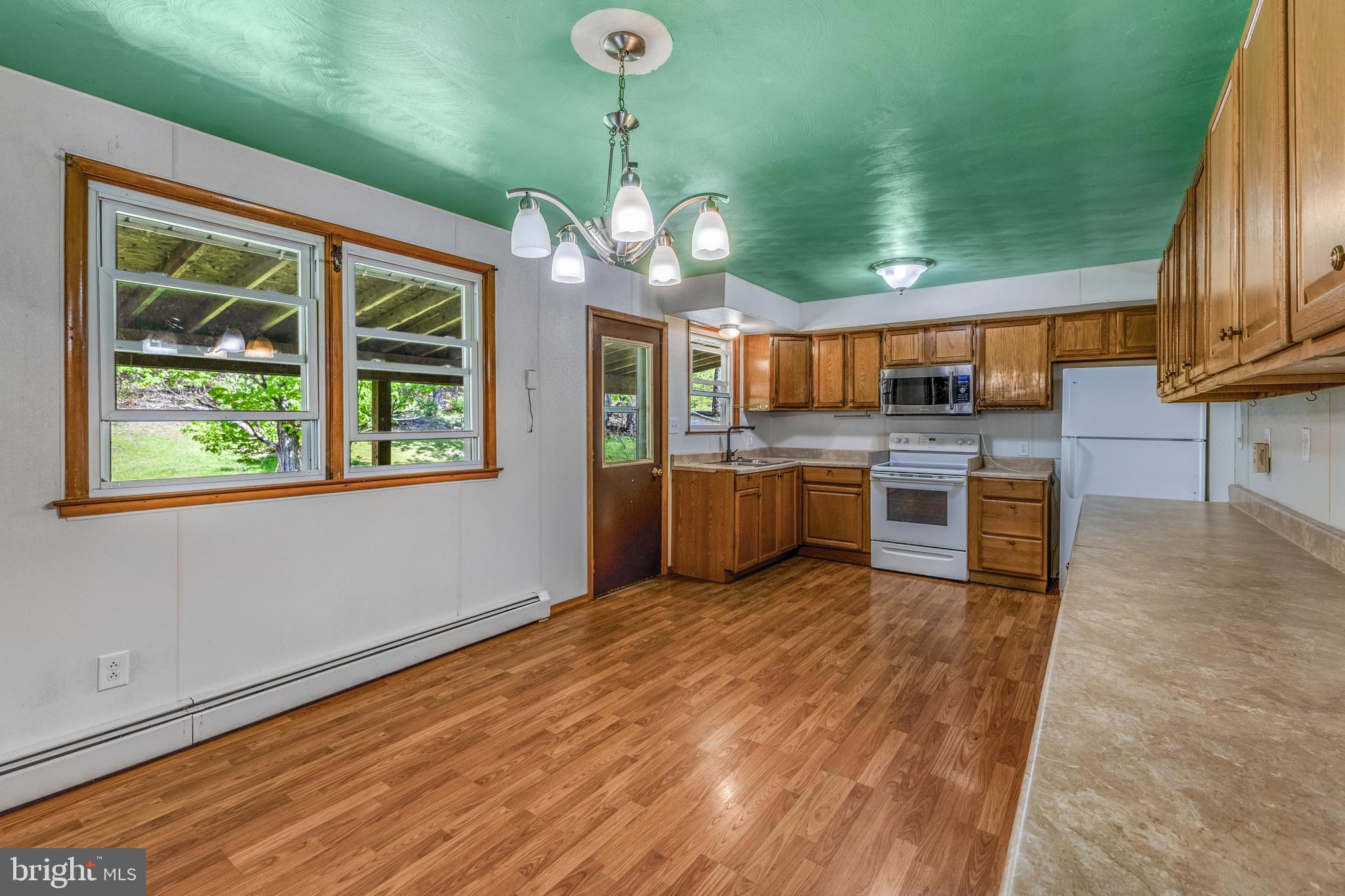 243 Lucas Road Bellefonte, PA 16823 - Photo 8 of 32 a view of a kitchen with a sink and dishwasher cabinets with wooden floor