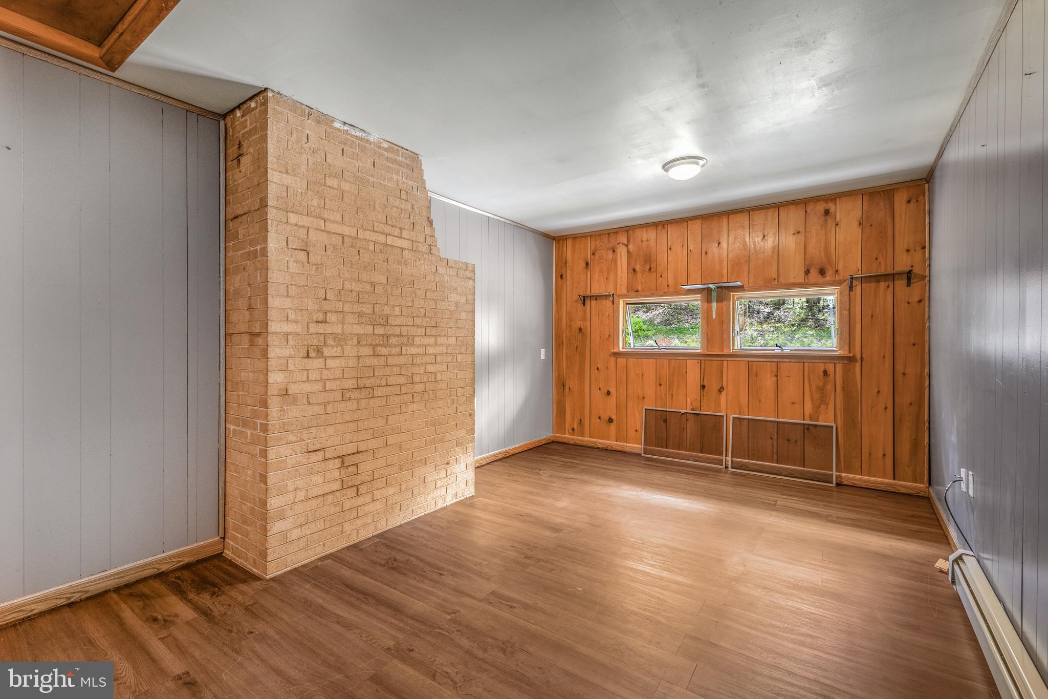 243 Lucas Road Bellefonte, PA 16823 - Photo 10 of 32 an empty room with wooden floor and windows with curtains