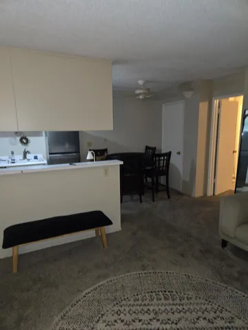 a room with furniture a air conditioner vent and a window