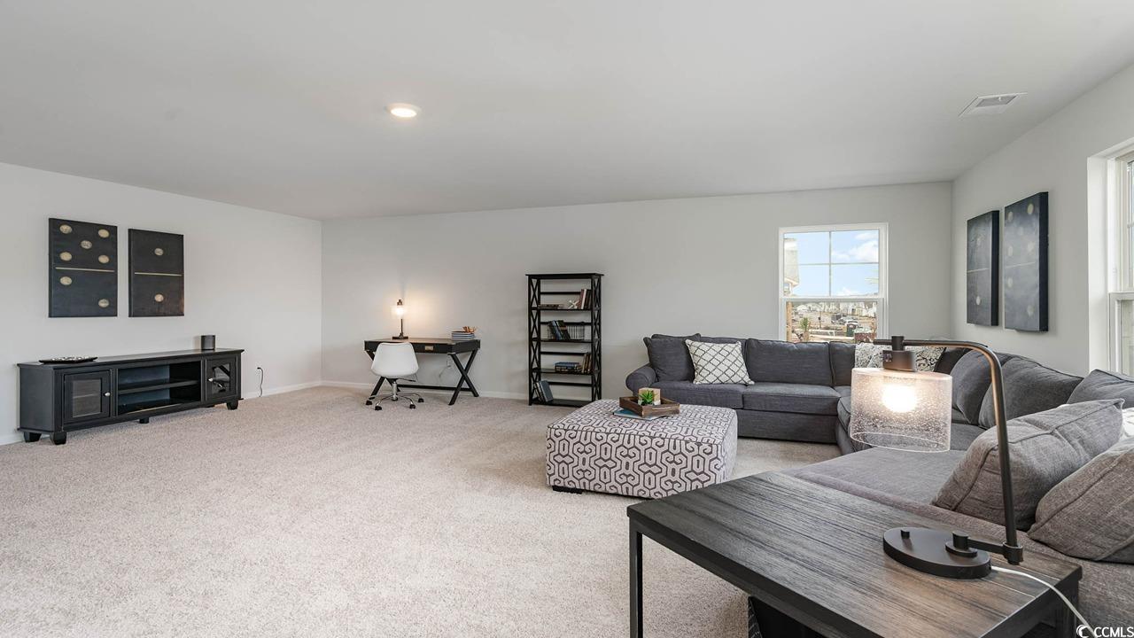 117 Keithland Drive Conway, SC 29527 - Photo 18 of 32 Living room with light colored carpet and baseboards