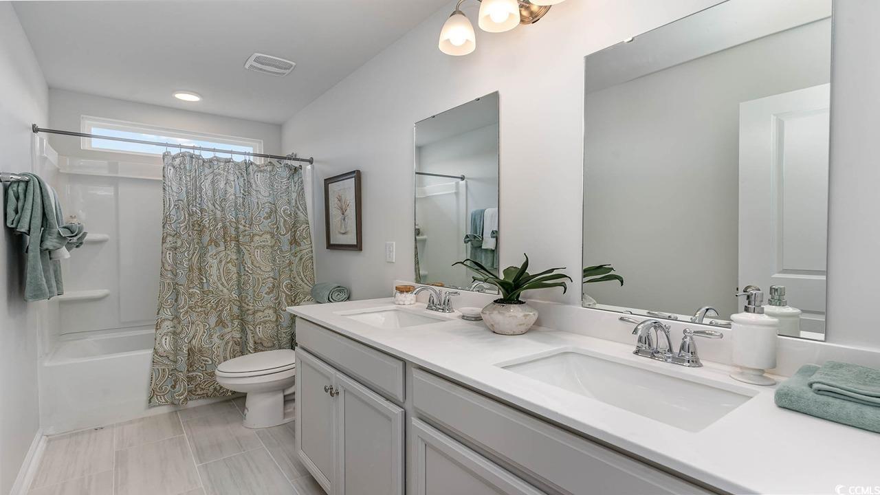 117 Keithland Drive Conway, SC 29527 - Photo 24 of 32 Bathroom featuring double vanity and shower / tub combo with curtain