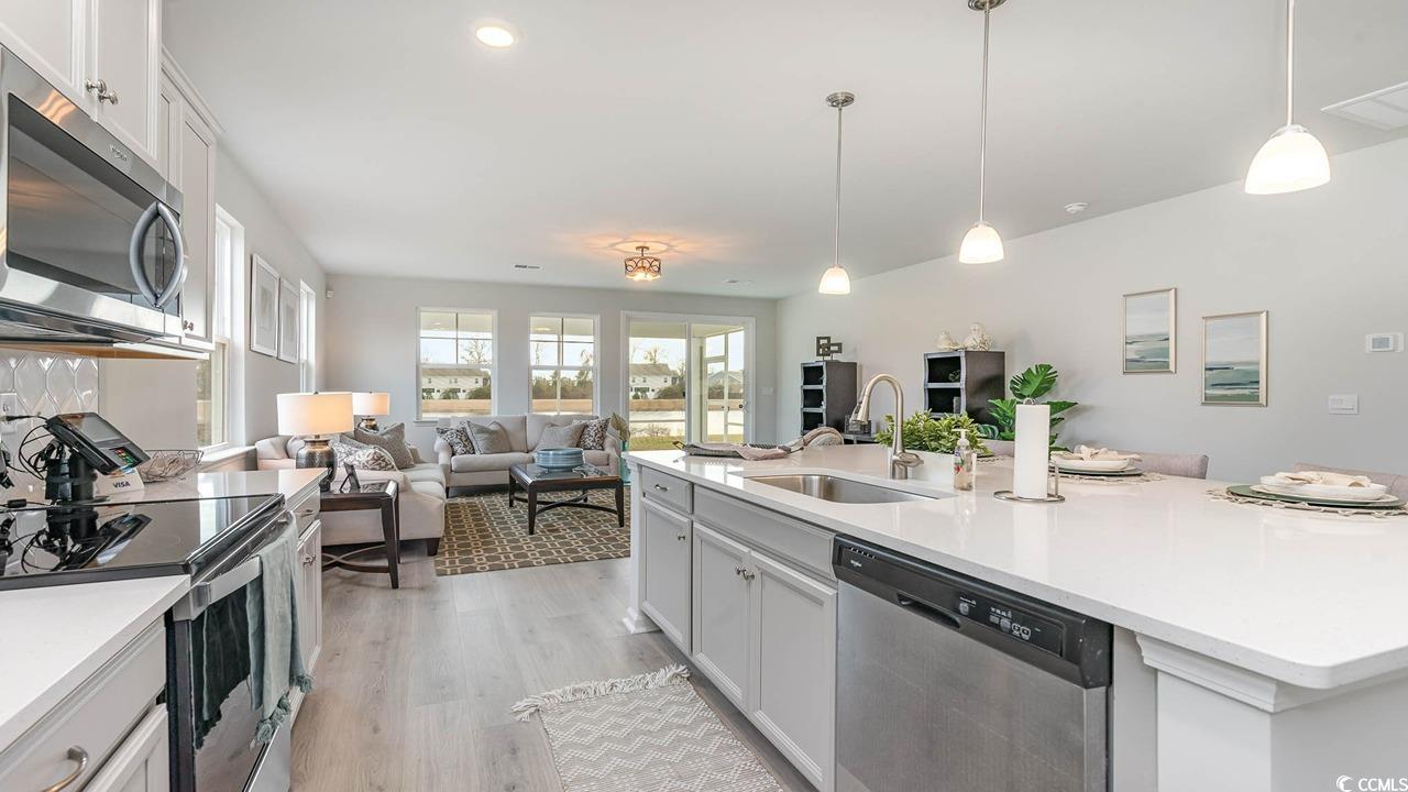 117 Keithland Drive Conway, SC 29527 - Photo 32 of 32 Kitchen with appliances with stainless steel finishes, open floor plan, light countertops, light wood-style floors, and an island with sink